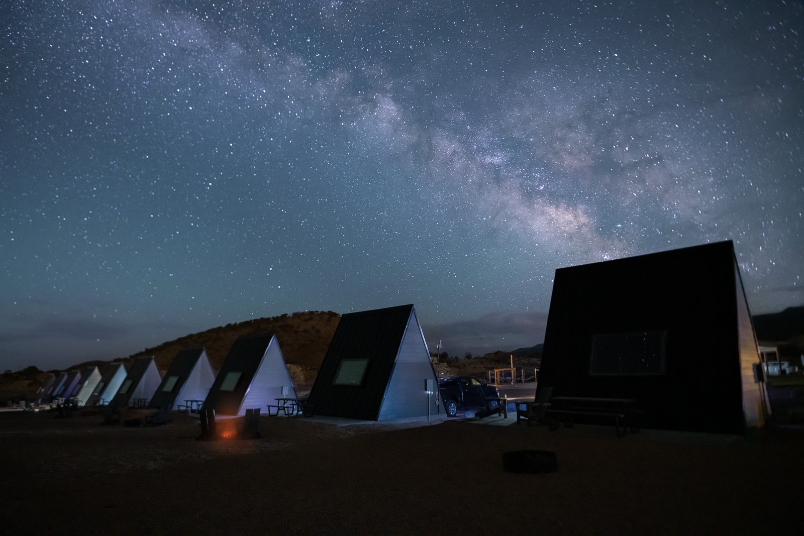 Milky Way above the resort's row of stargazing A-frame cabins at night